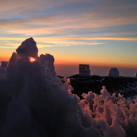 a person with a sunset in the background