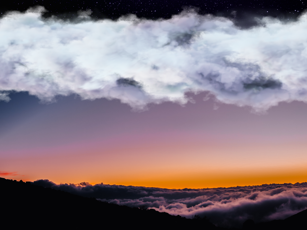 a sunset over a body of water with a mountain in the background
