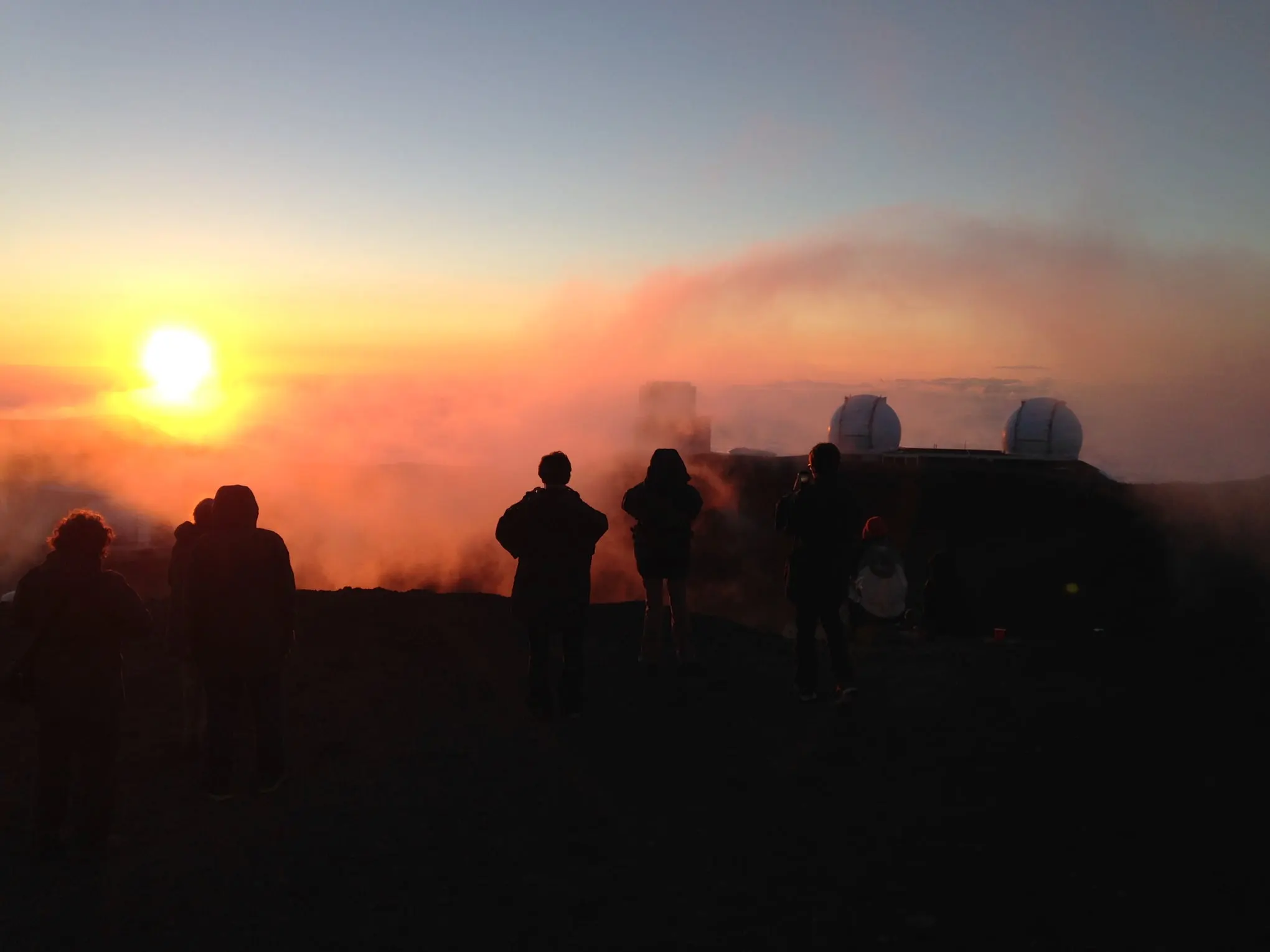 a man standing in front of a sunset