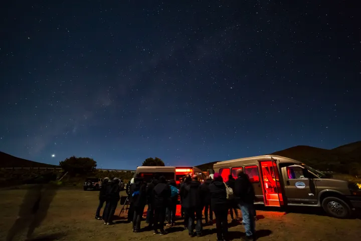 a group of people riding on the back of a truck